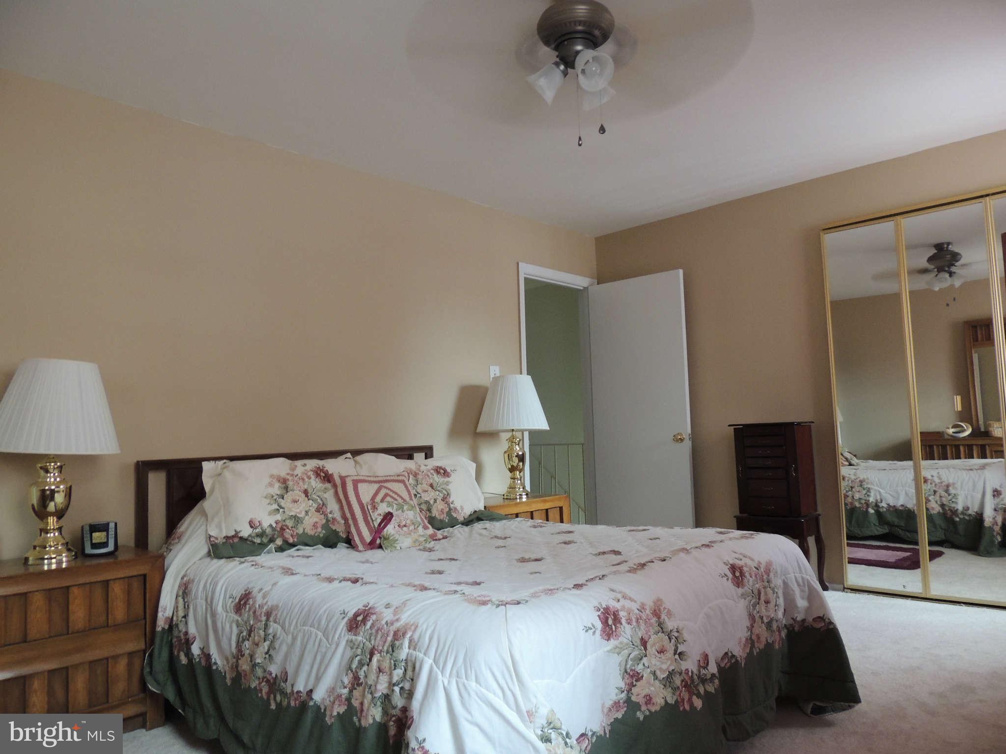3795 Port Hope Point Triangle, VA 22172 - Photo 15 of 26 a bedroom with a bed and a lamp