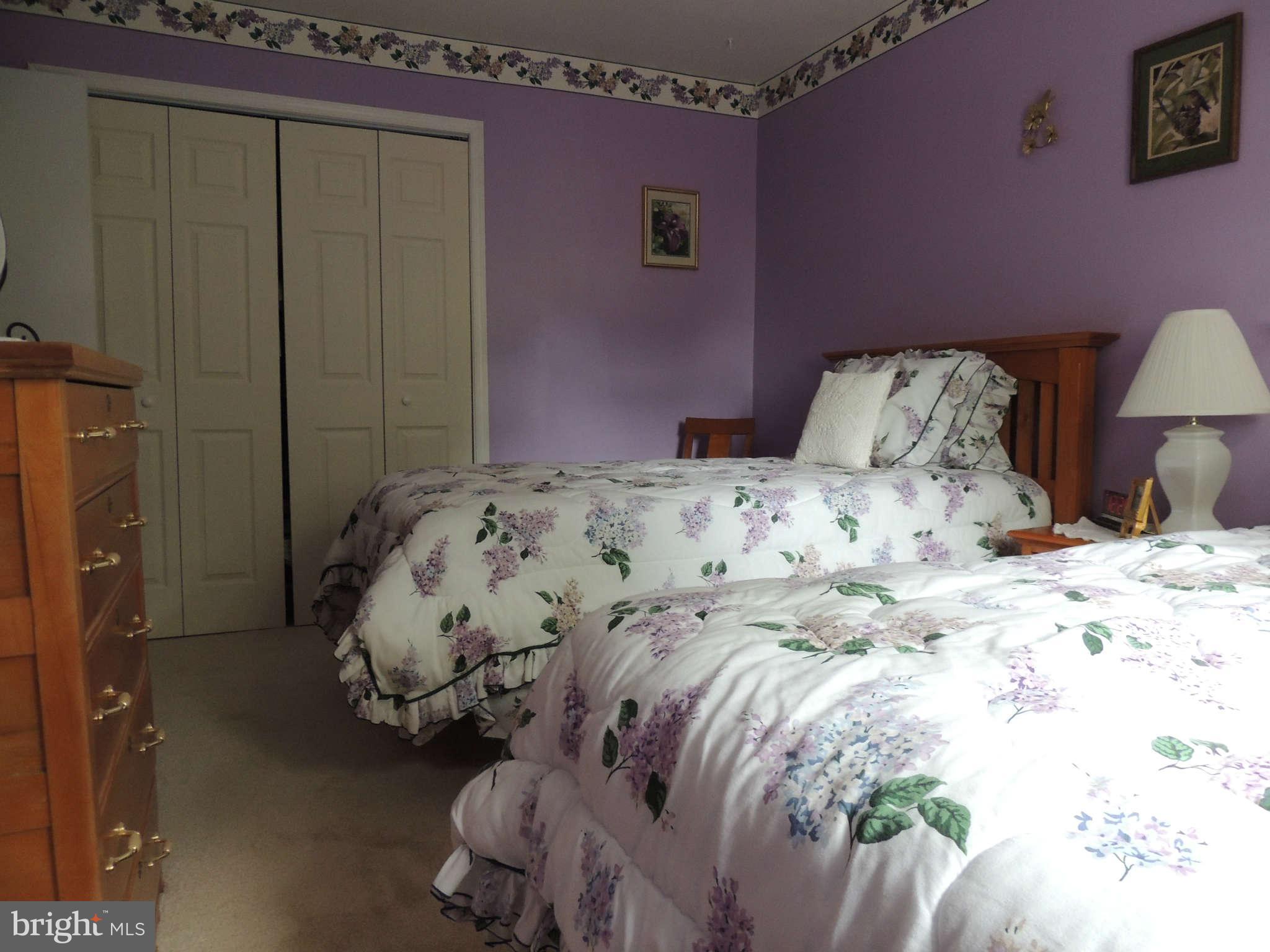 3795 Port Hope Point Triangle, VA 22172 - Photo 18 of 26 a bed sitting in a bedroom next to a wooden cabinet
