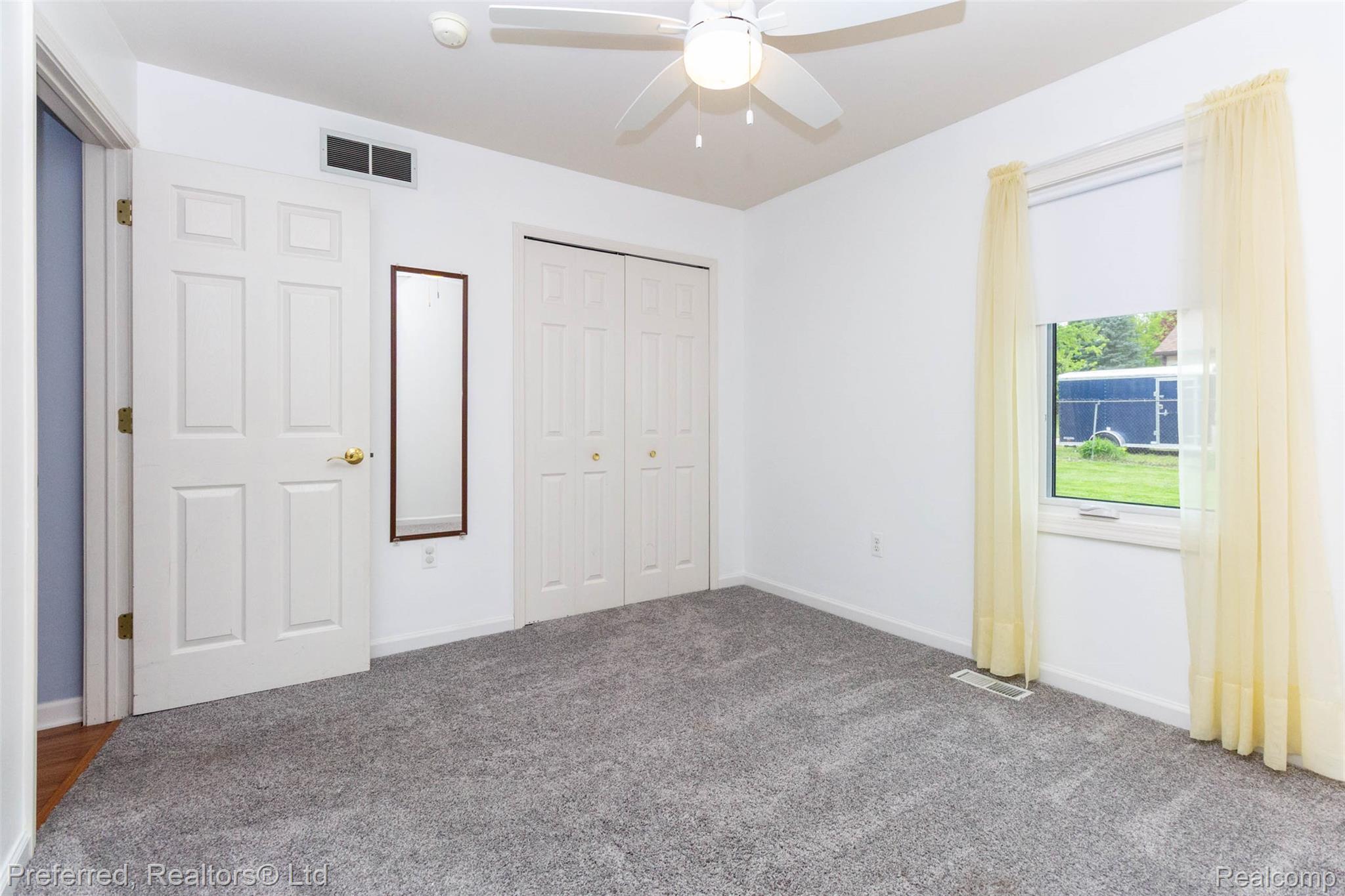 9840 Currie Road Northville, MI 48167 - Photo 28 of 62 Unfurnished bedroom featuring a closet, a ceiling fan, and carpet floors