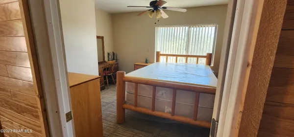 a kitchen with stainless steel appliances granite countertop furniture wooden floor and a window