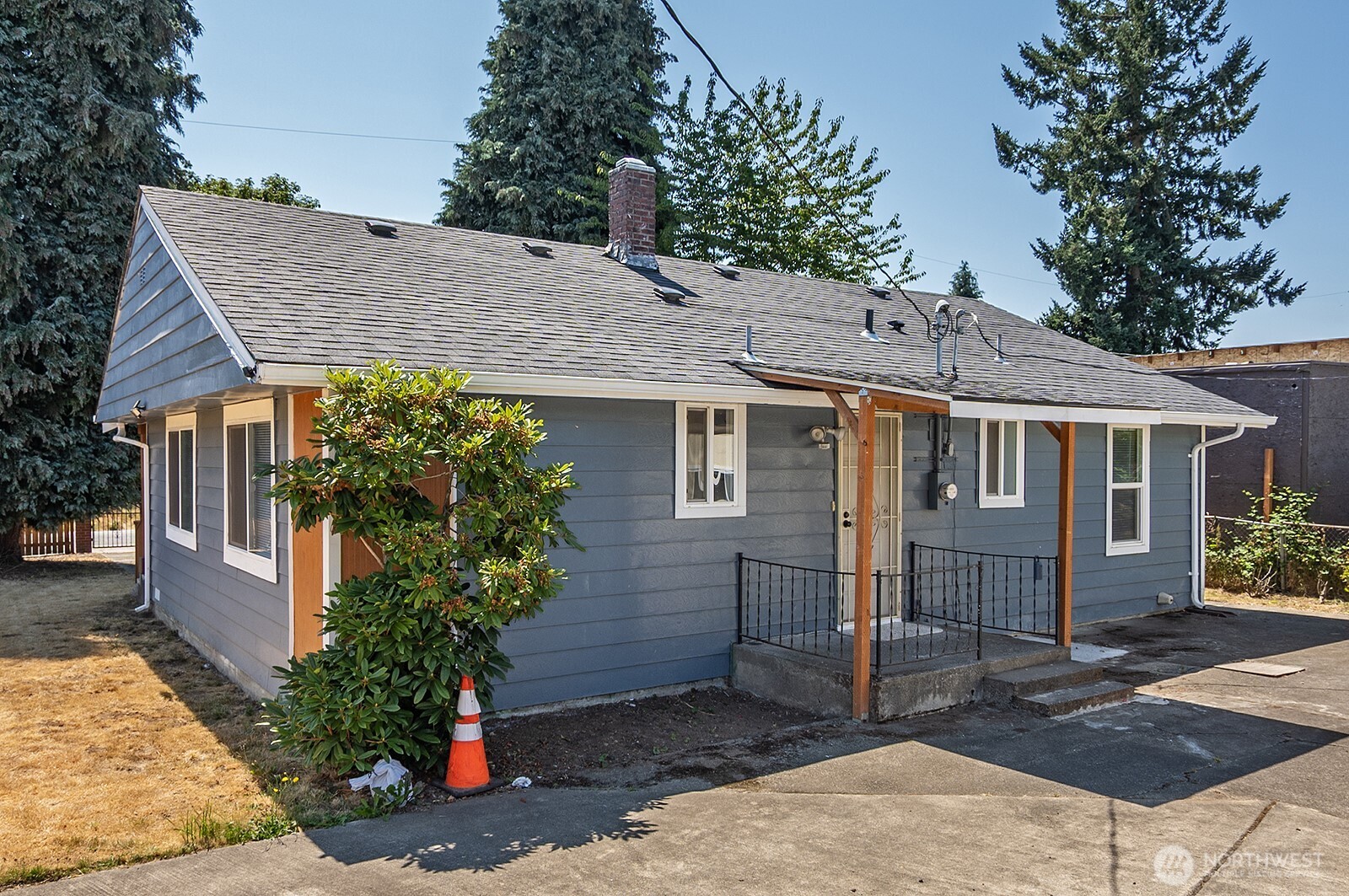 7660 South 126th Street Seattle, WA 98178 - Photo 11 of 33 a view of a house with a small yard plants and large tree