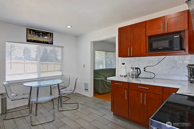a utility room with wooden floor washer and dryer