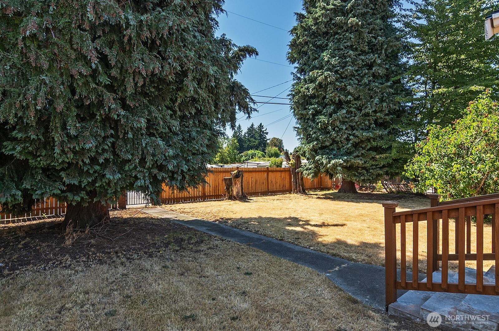 7660 South 126th Street Seattle, WA 98178 - Photo 6 of 33 a wooden bench with view of trees