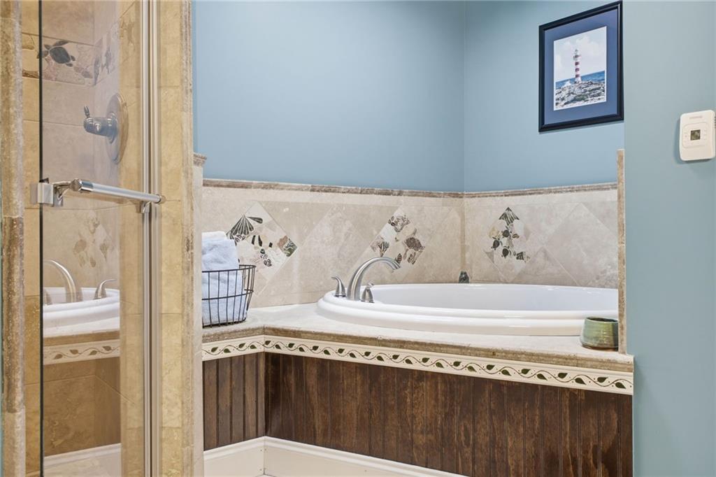 6729 Big Texas Valley Road Northwest Rome, GA 30165 - Photo 71 of 95 a bathroom with a bathtub and a shower
