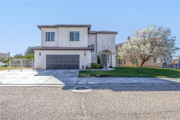 a front view of a house with a yard and a garage