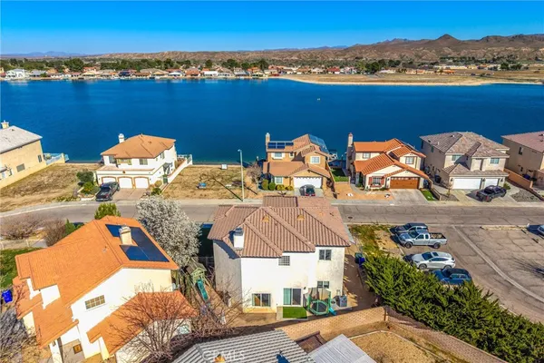 an aerial view of a houses with a swimming pool