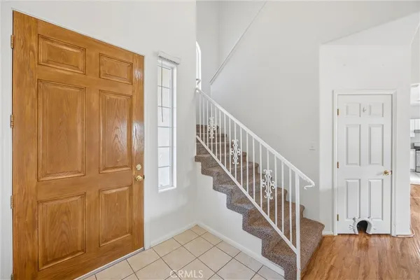 a view of a hallway with wooden floor and entryway