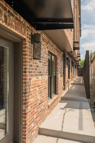 a view of a brick house with many windows