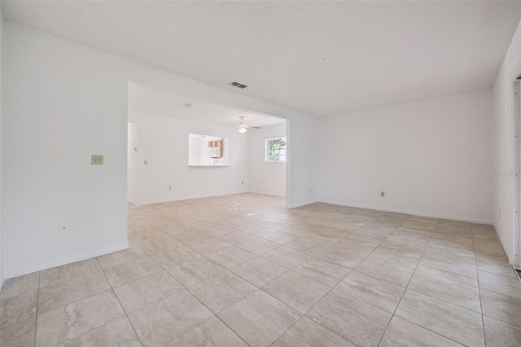 498 Green Spring Circle Winter Springs, FL 32708 - Photo 4 of 20 an empty room with a empty space and windows