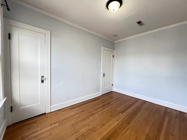 a view of room with wooden floor