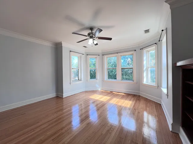 a view of a hallway with wooden floor and closet