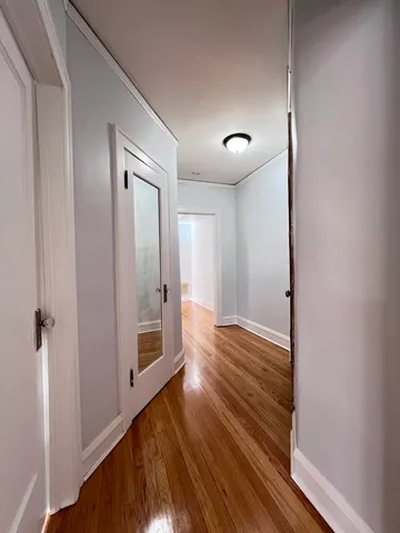 a view of a room with wooden floor