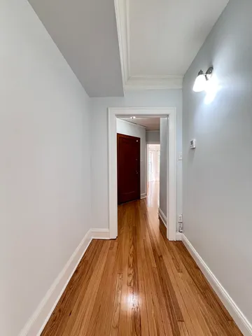 a view of a room with wooden floor