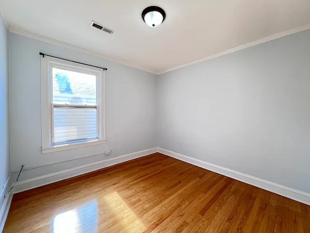 a view of a room with wooden floor and white walls