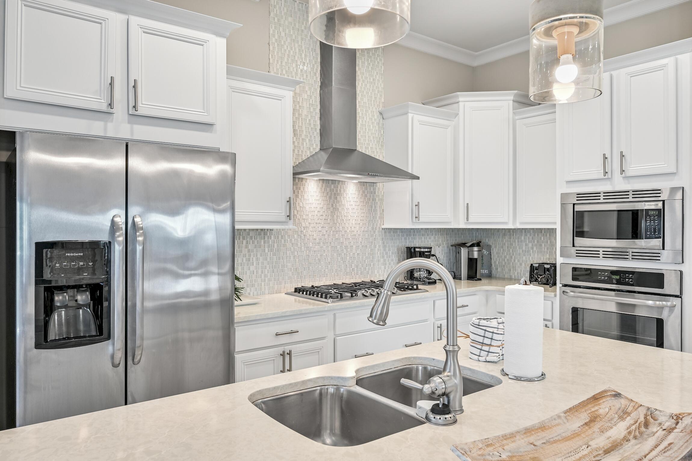 35 East Milestone Dr Inlet Beach, Unit A Inlet Beach, FL 32461 - Photo 11 of 45 a kitchen with stainless steel appliances kitchen island granite countertop a refrigerator and a sink