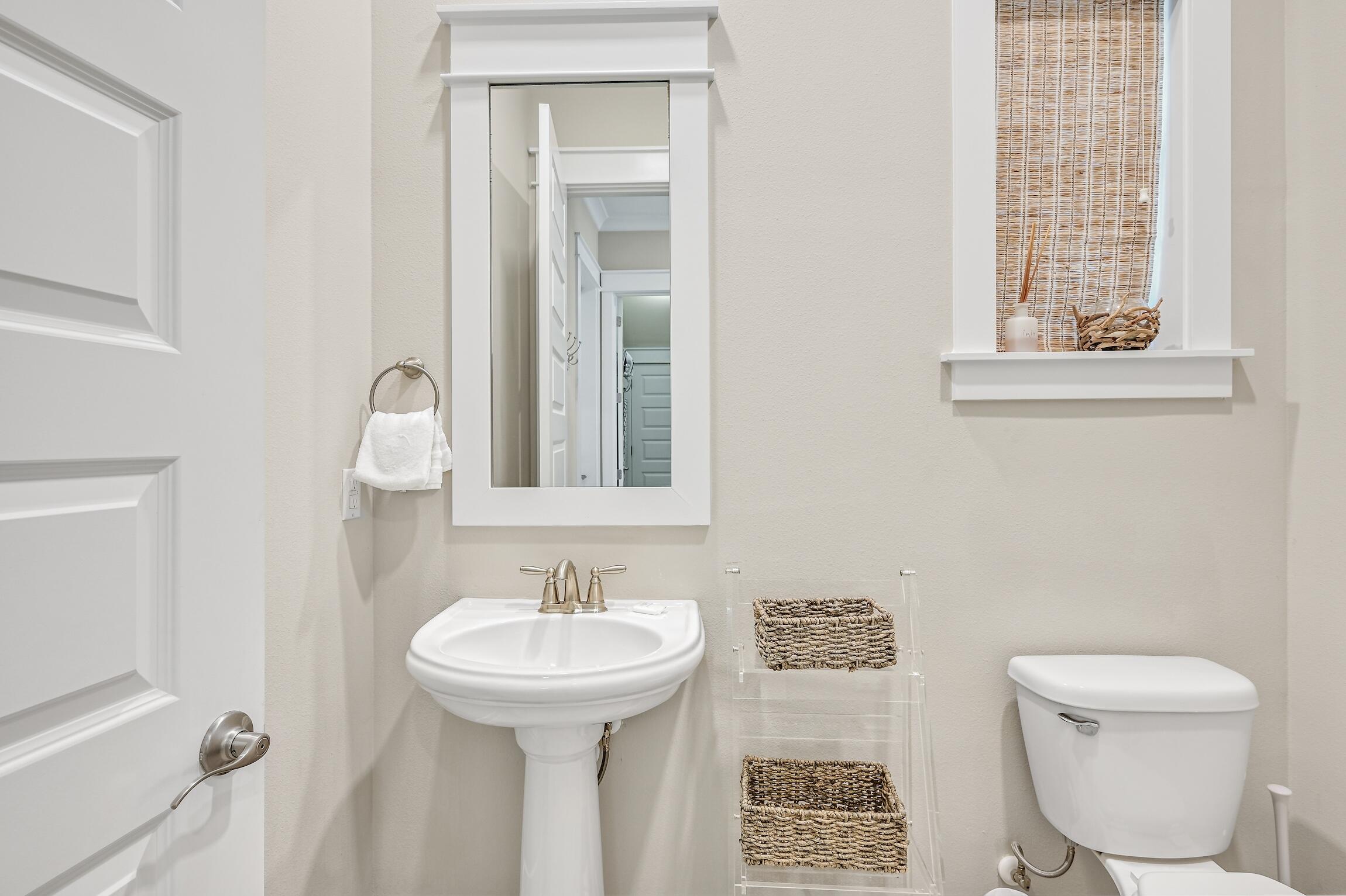 35 East Milestone Dr Inlet Beach, Unit A Inlet Beach, FL 32461 - Photo 16 of 45 a bathroom with a toilet sink and mirror