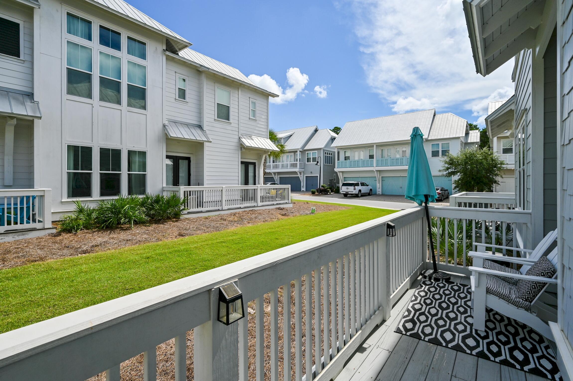 35 East Milestone Dr Inlet Beach, Unit A Inlet Beach, FL 32461 - Photo 30 of 45 a view of a house with a small yard and wooden fence