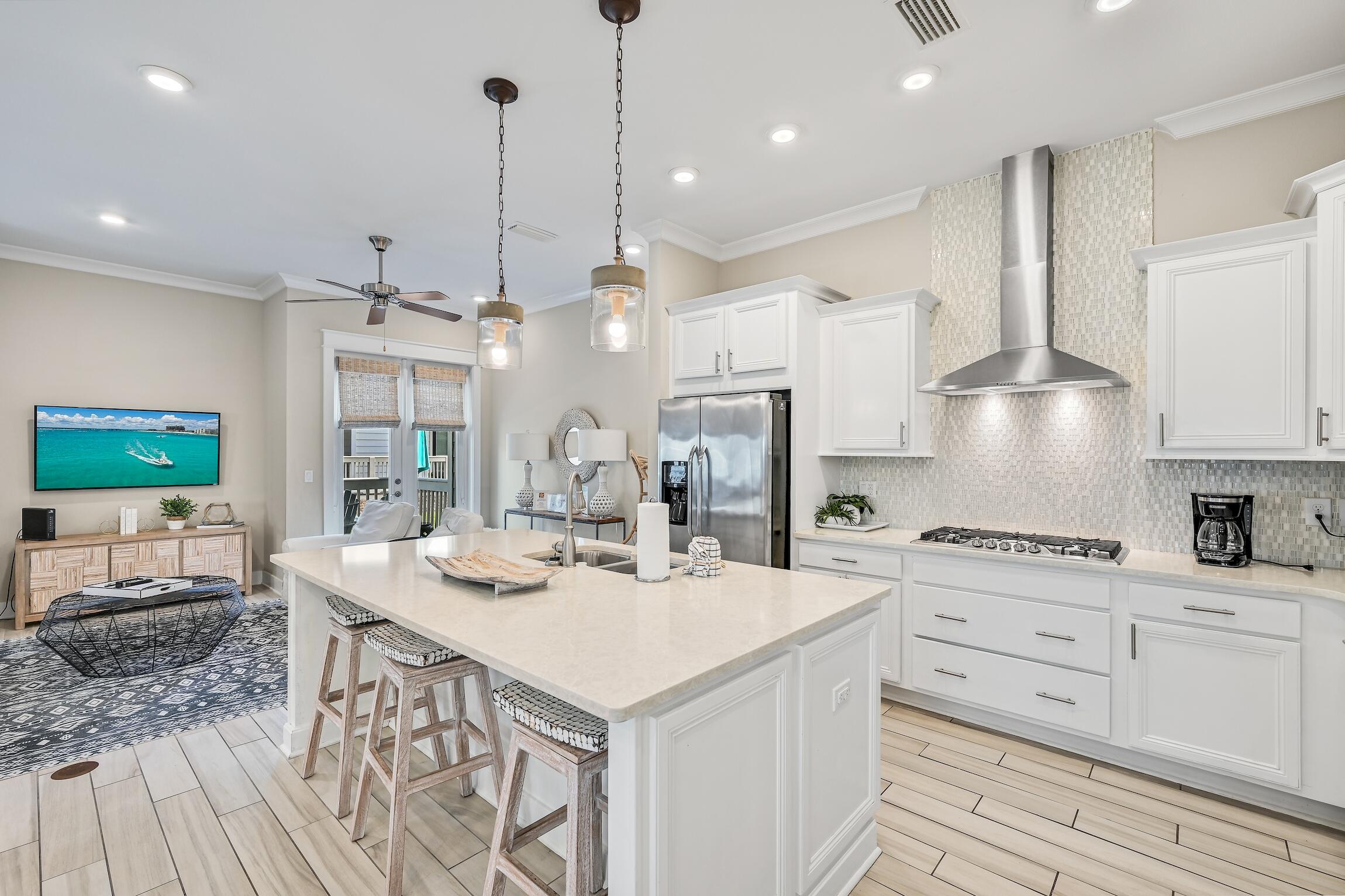 35 East Milestone Dr Inlet Beach, Unit A Inlet Beach, FL 32461 - Photo 8 of 45 a kitchen with stainless steel appliances kitchen island granite countertop a sink a stove and a refrigerator