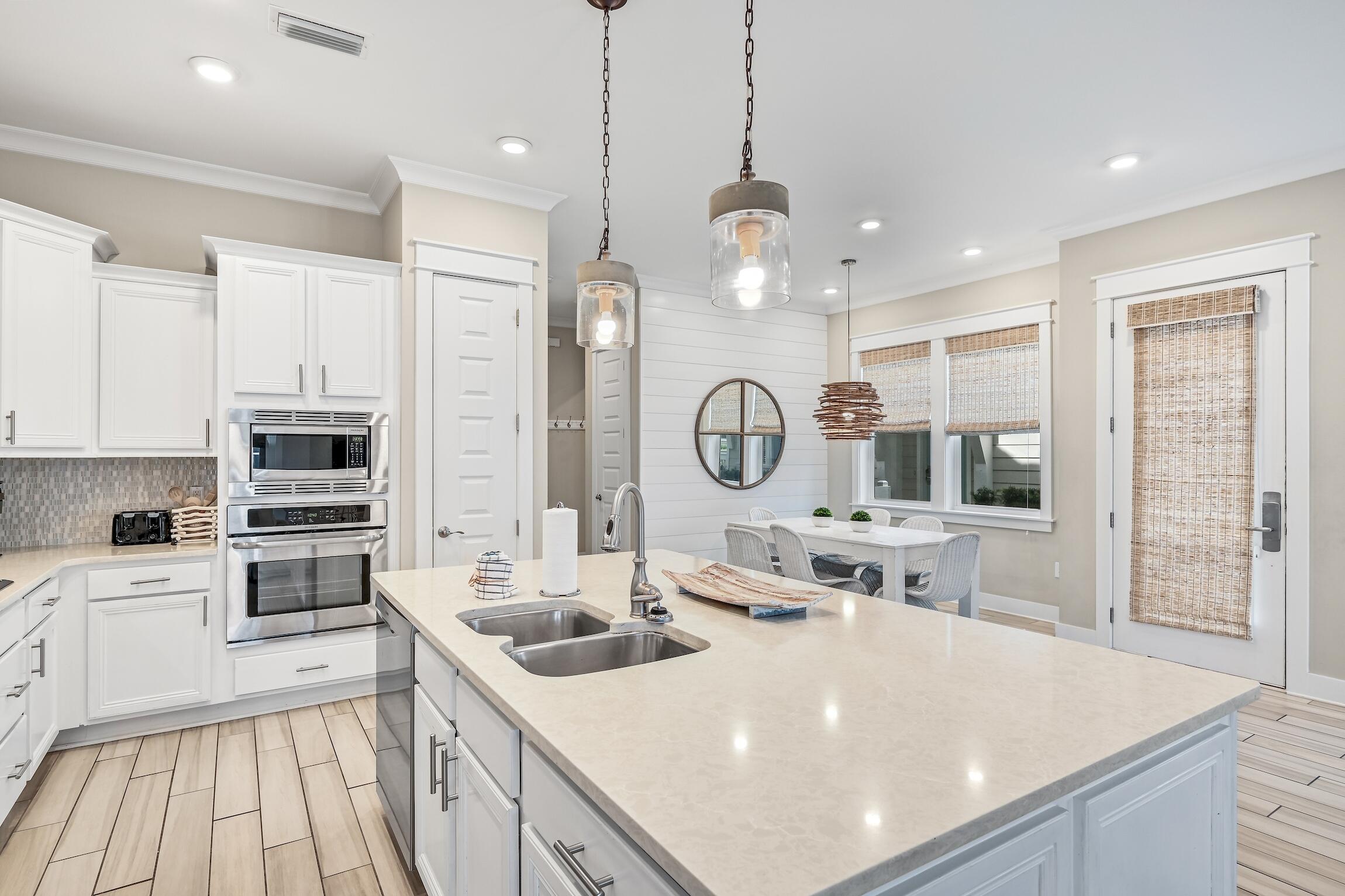 35 East Milestone Dr Inlet Beach, Unit A Inlet Beach, FL 32461 - Photo 9 of 45 a large kitchen with kitchen island a stove a sink a center island and furniture