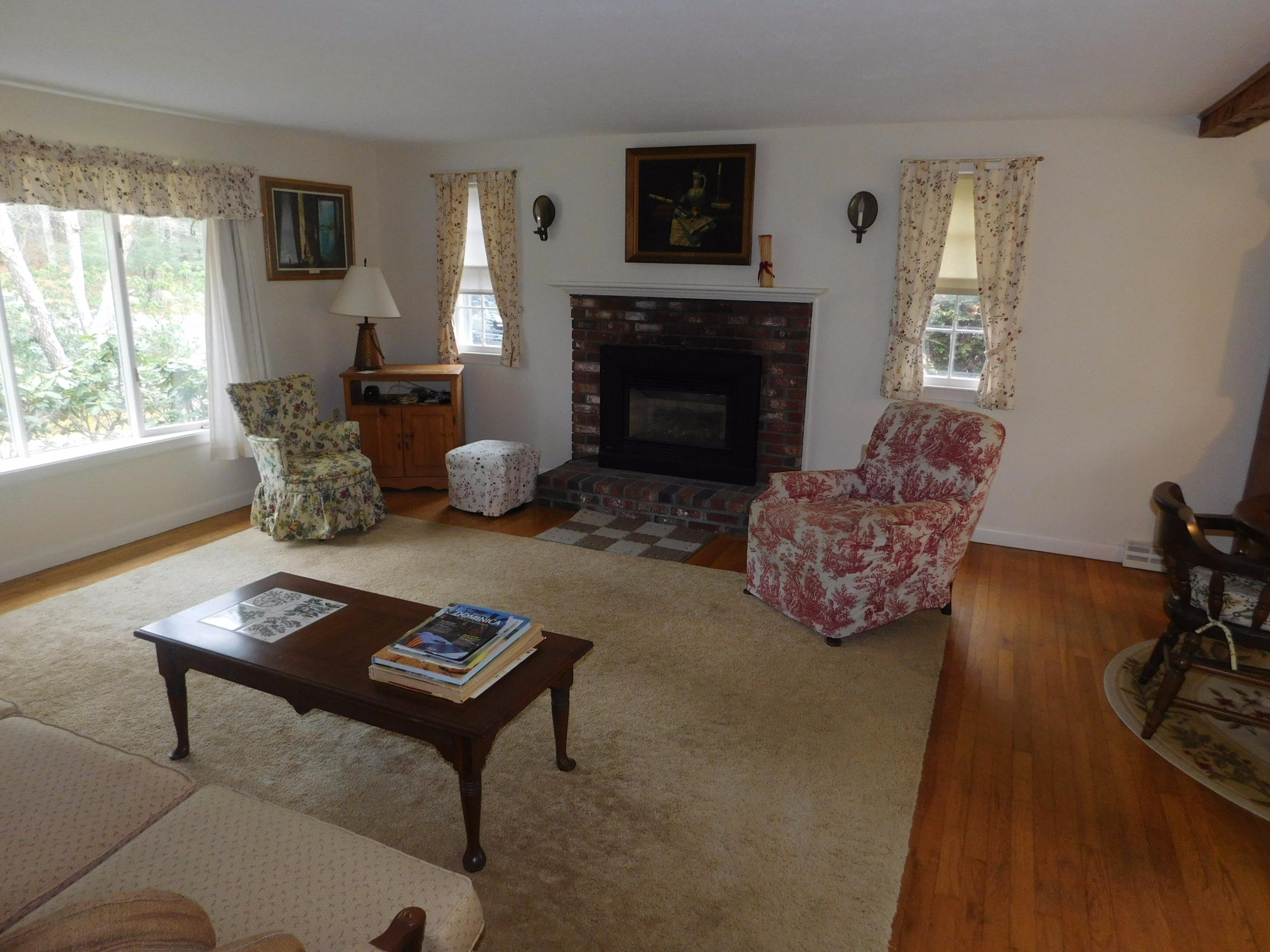 202 Woodside Road West Barnstable, MA 02668 - Photo 11 of 21 a living room with furniture and a fireplace