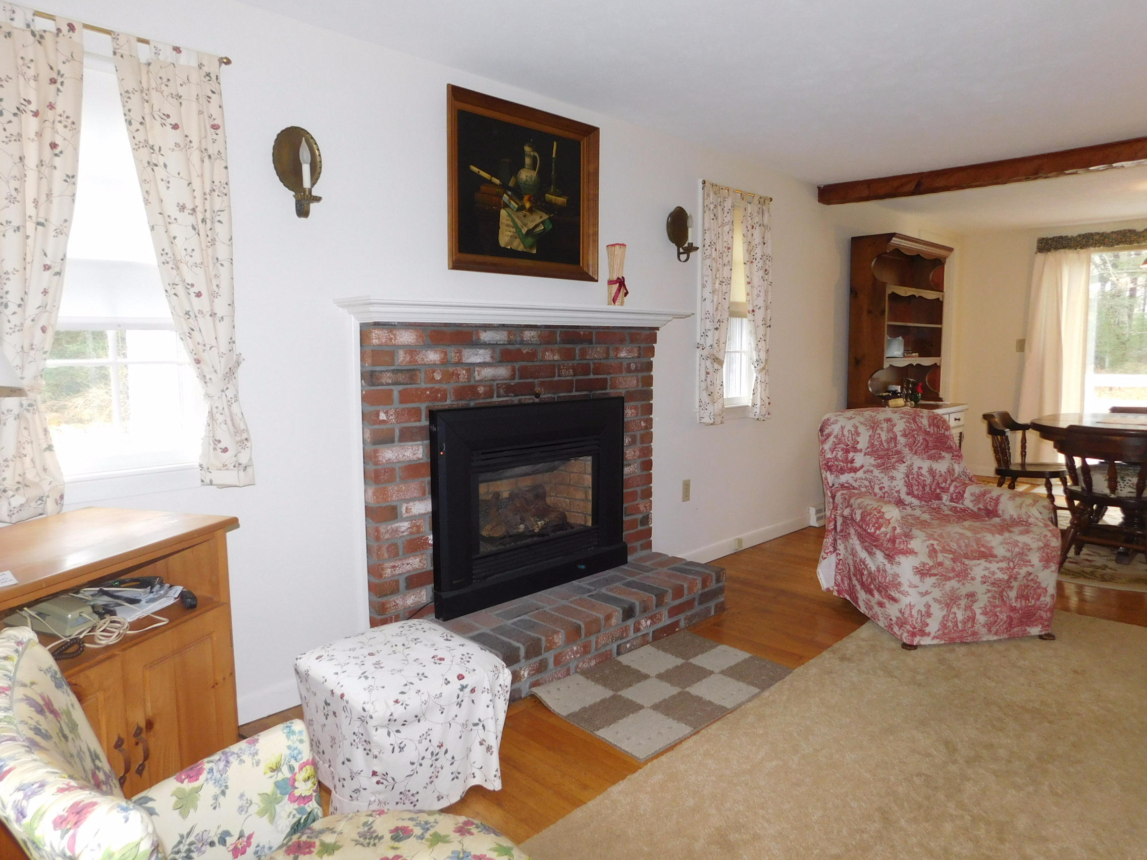 202 Woodside Road West Barnstable, MA 02668 - Photo 12 of 21 a living room with furniture and a fireplace