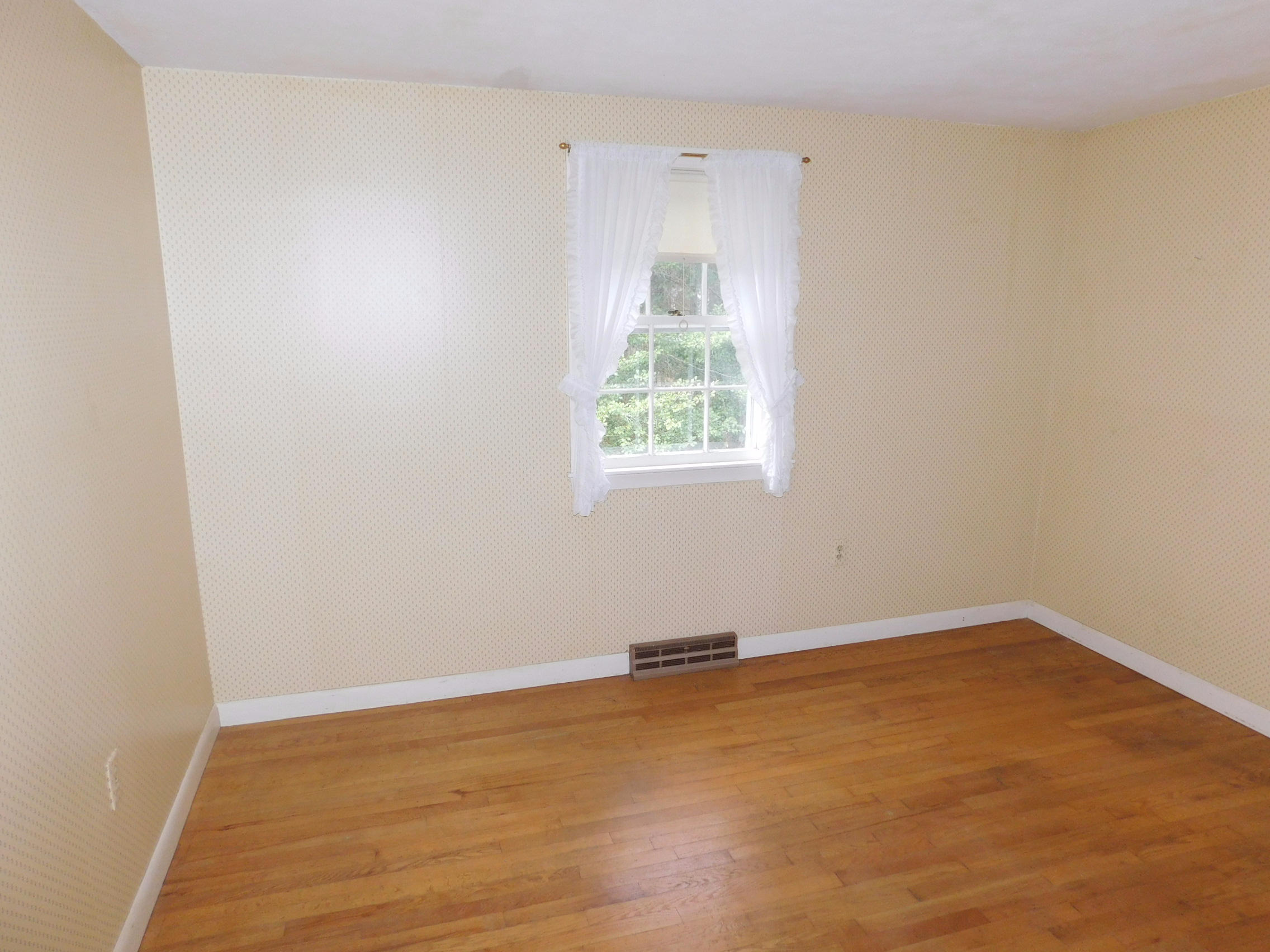 202 Woodside Road West Barnstable, MA 02668 - Photo 20 of 21 an empty room with wooden floor and windows