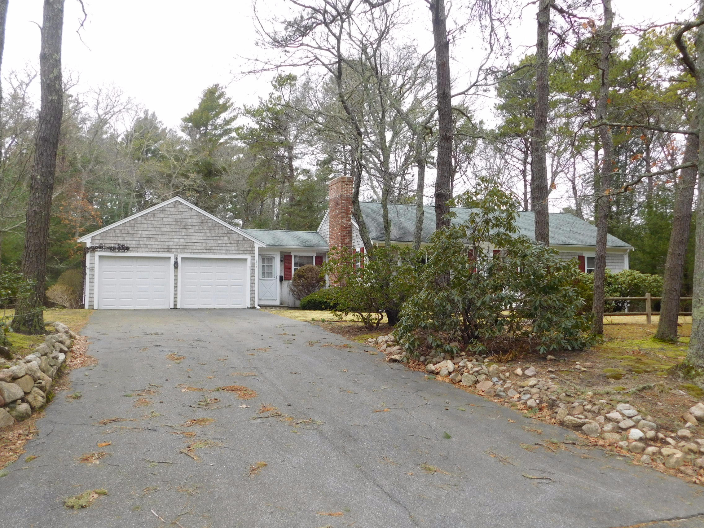 202 Woodside Road West Barnstable, MA 02668 - Photo 2 of 21 a house with trees in front of it