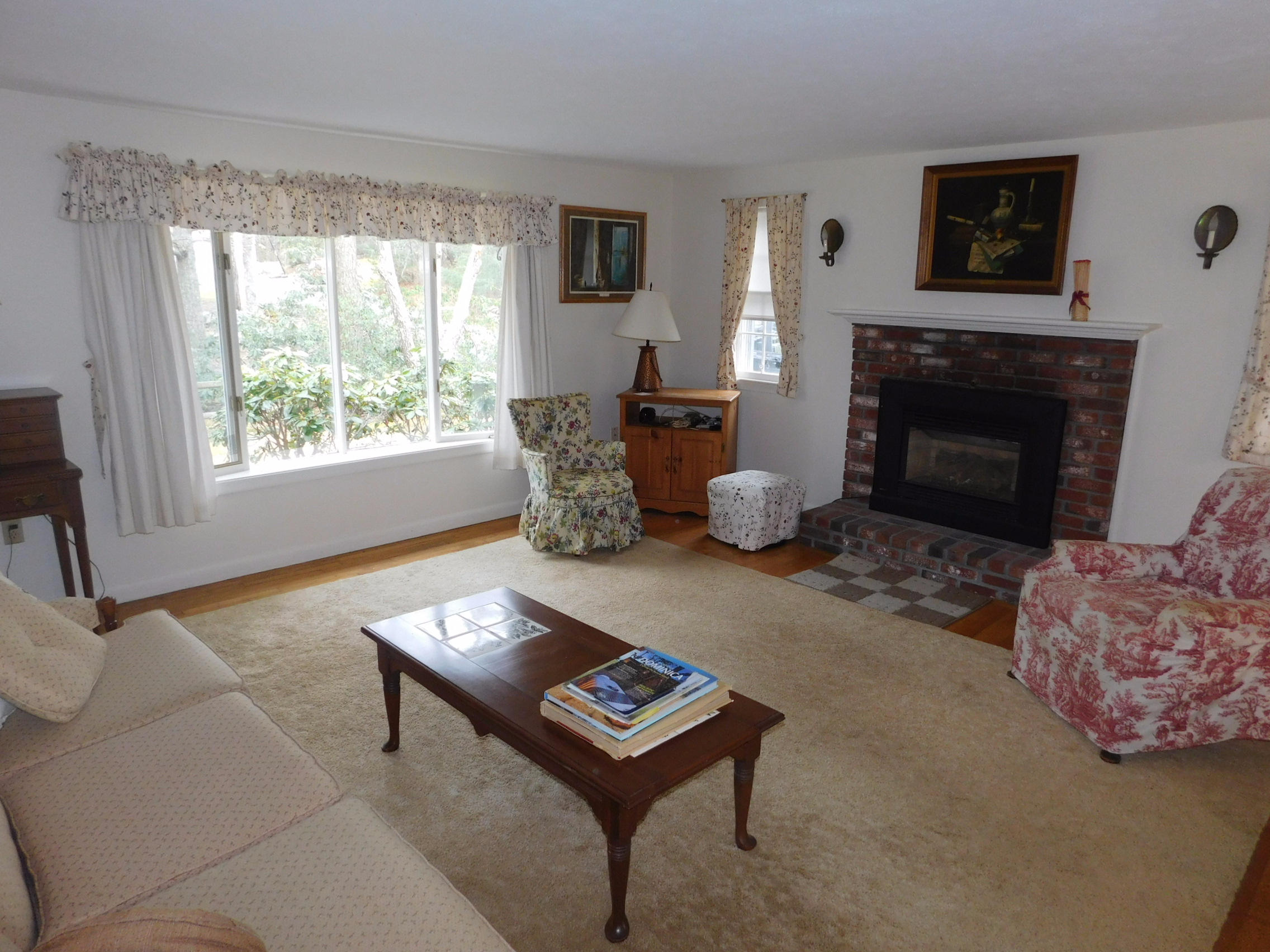 202 Woodside Road West Barnstable, MA 02668 - Photo 10 of 21 a living room with furniture and a fireplace