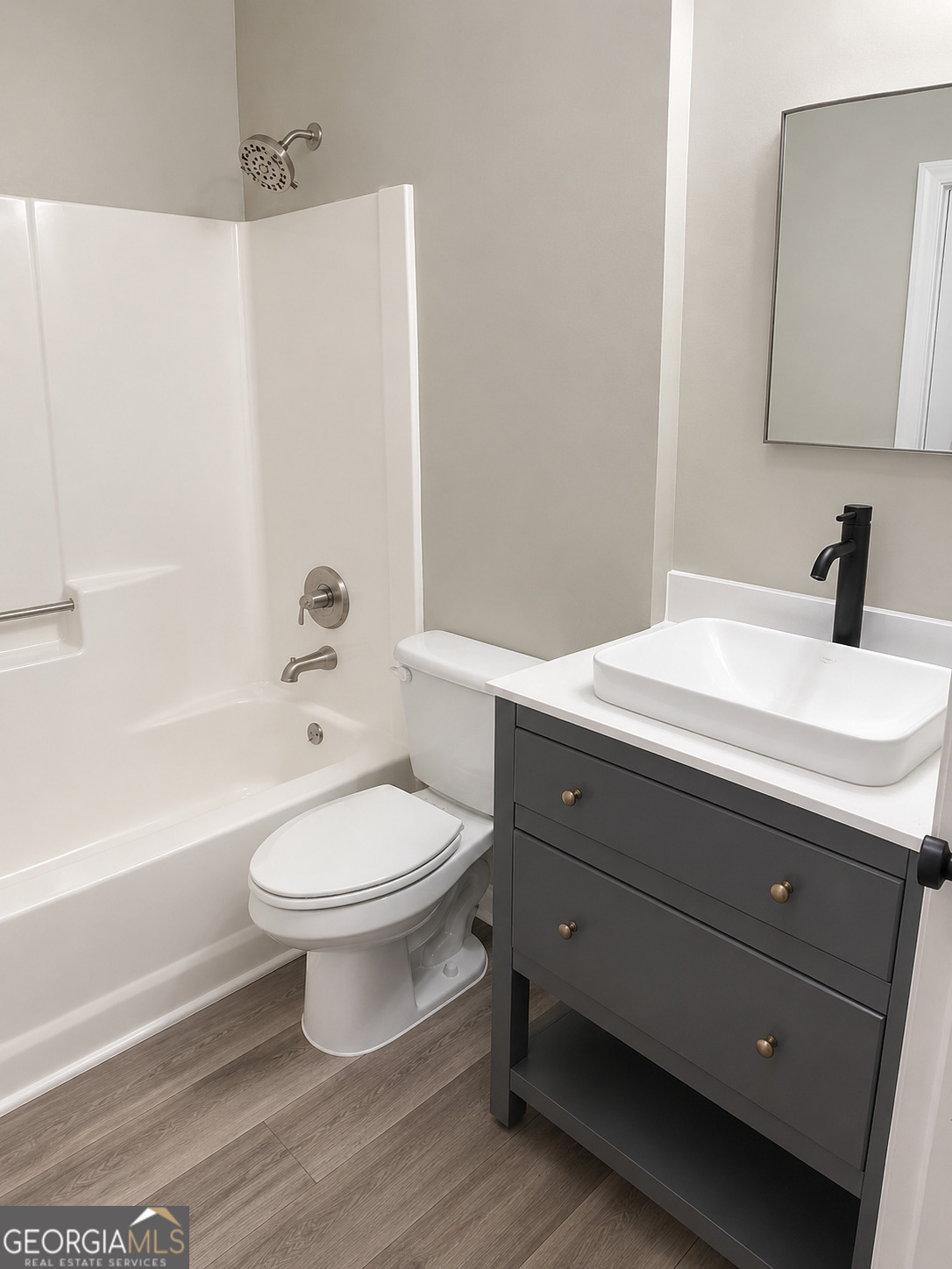 105 Dailey Mill Road McDonough, GA 30253 - Photo 17 of 19 a bathroom with a toilet a sink a mirror and bathtub