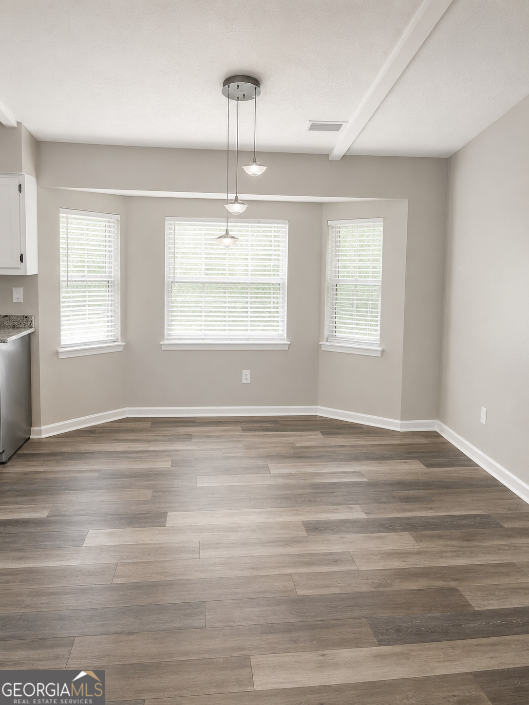 105 Dailey Mill Road McDonough, GA 30253 - Photo 5 of 19 a view of empty room with wooden floor and window