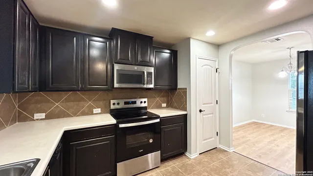 a kitchen with a refrigerator and a sink