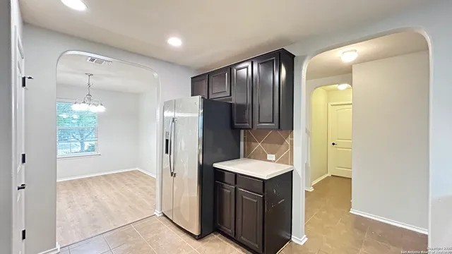 a spacious bathroom with a mirror sink and shower
