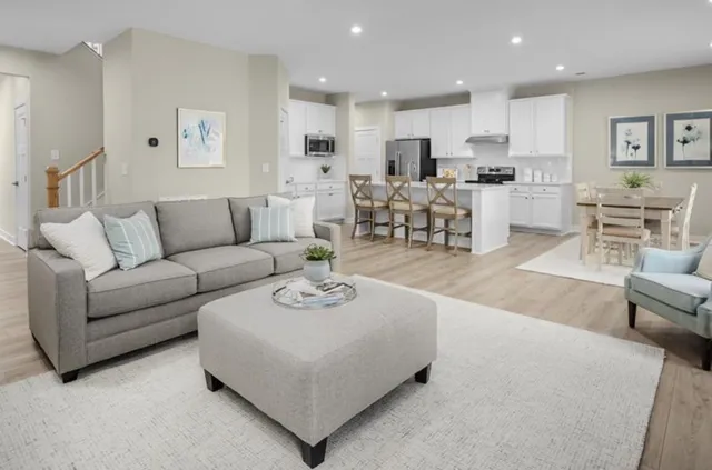 a living room with furniture and kitchen view
