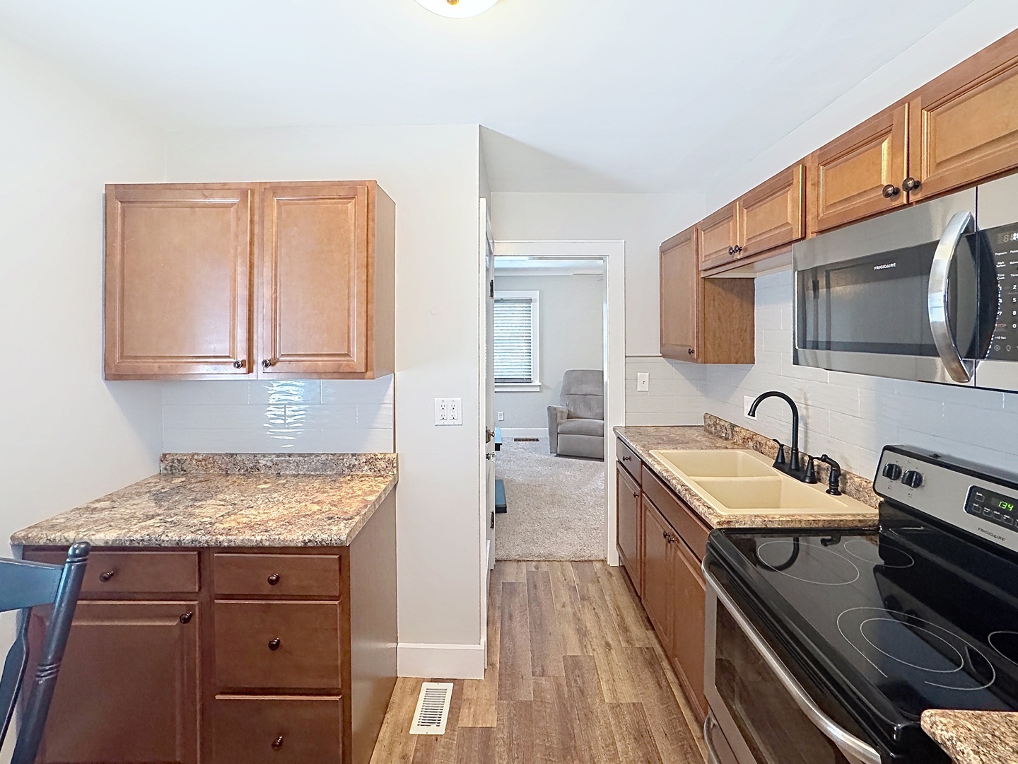 1841 32nd Street Moline, IL 61265 - Photo 7 of 24 a spacious bathroom with a granite countertop sink a stove and a microwave