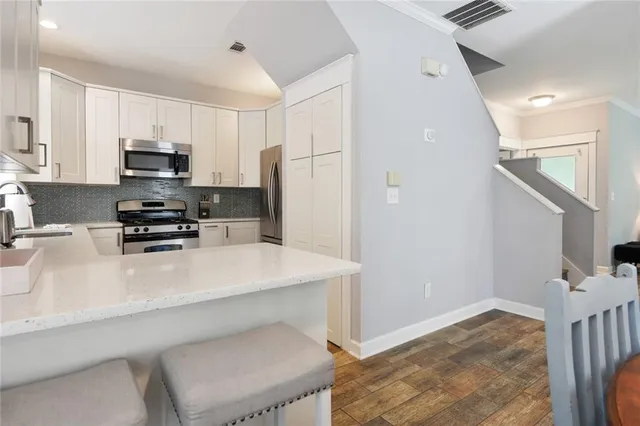 a kitchen with a refrigerator and a stove top oven