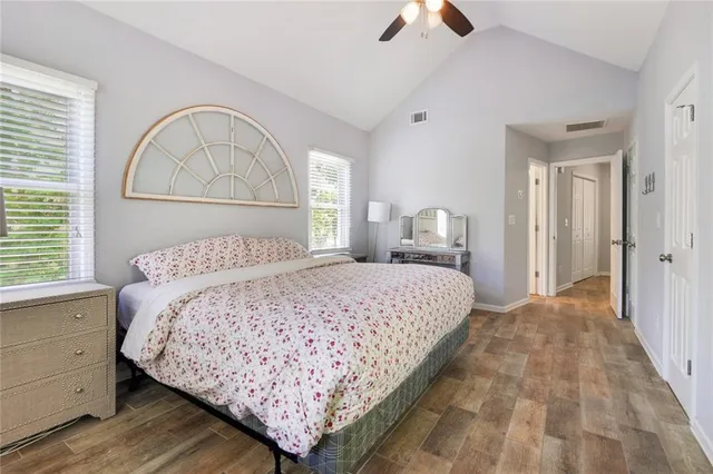 a bedroom with a large bed and a chandelier