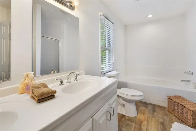 a bathroom with a sink a toilet and bathtub