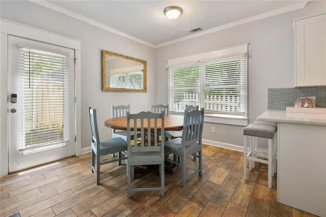 a dining room with furniture window and wooden floor