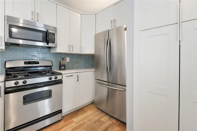a kitchen with stainless steel appliances a refrigerator microwave and sink