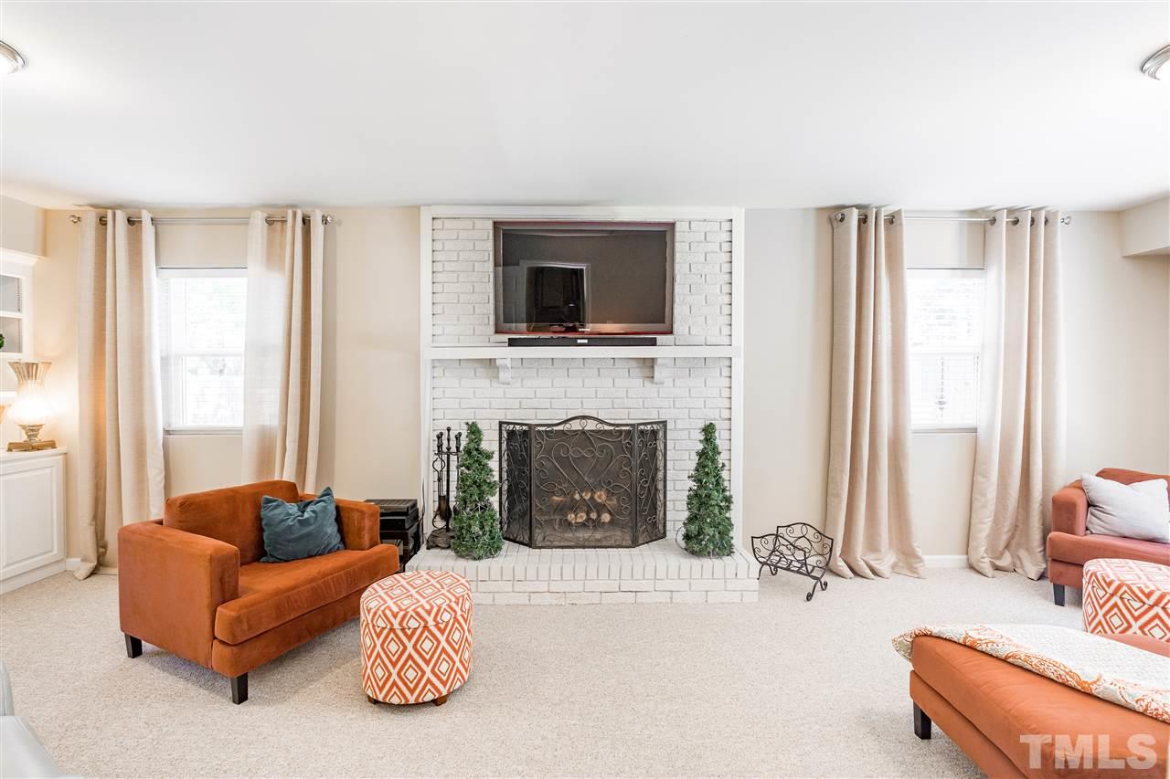 1005 Plateau Lane Raleigh, NC 27615 - Photo 16 of 29 a living room with furniture and a fireplace