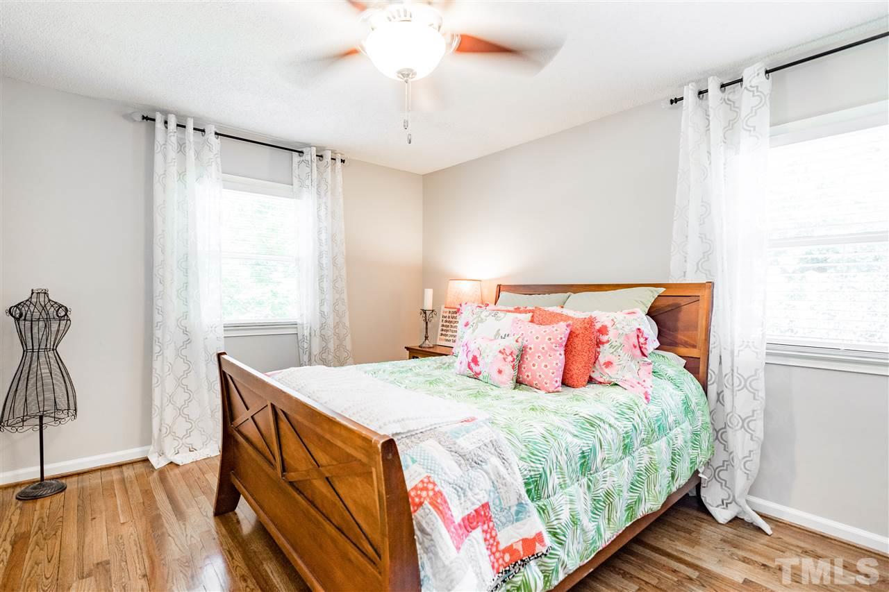 1005 Plateau Lane Raleigh, NC 27615 - Photo 20 of 29 a bedroom with a bed and a chandelier