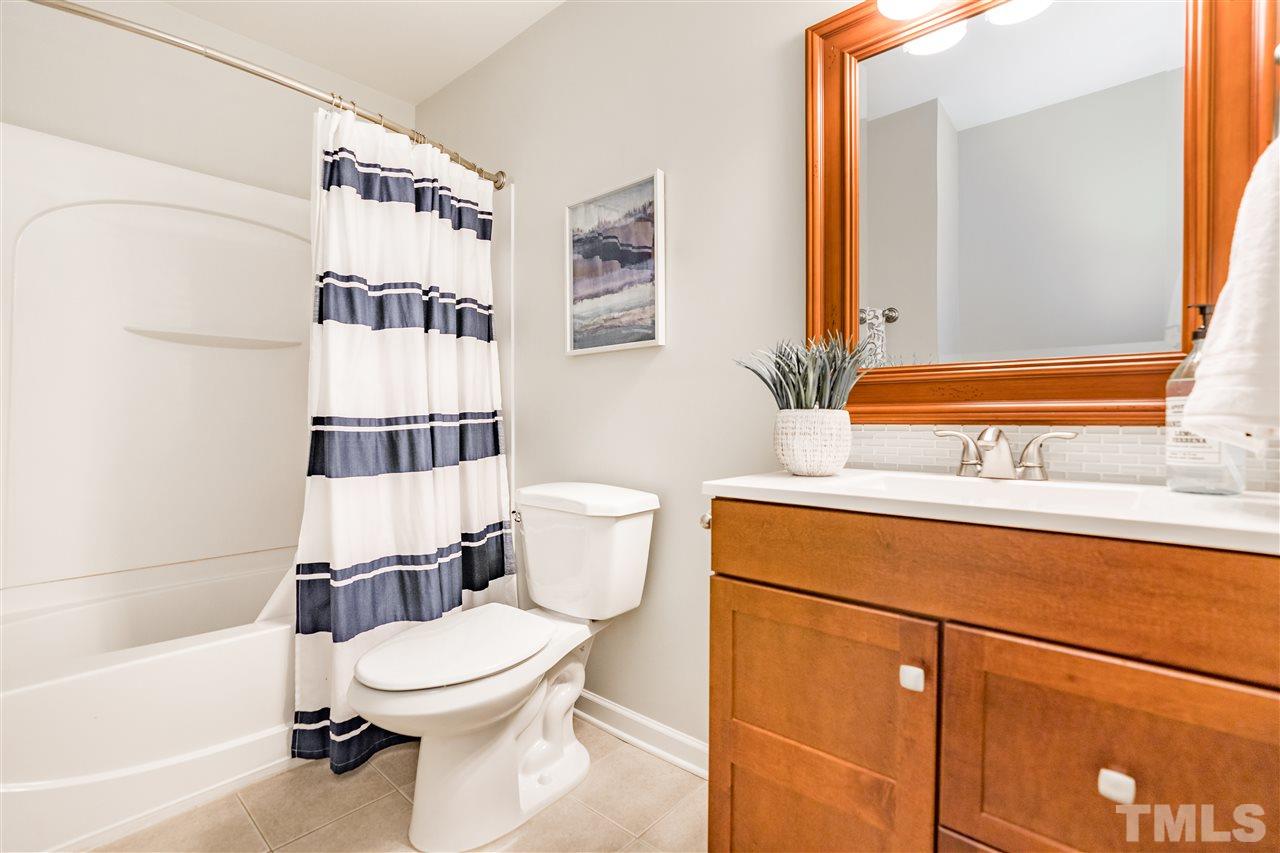 1005 Plateau Lane Raleigh, NC 27615 - Photo 22 of 29 a bathroom with a sink toilet and shower