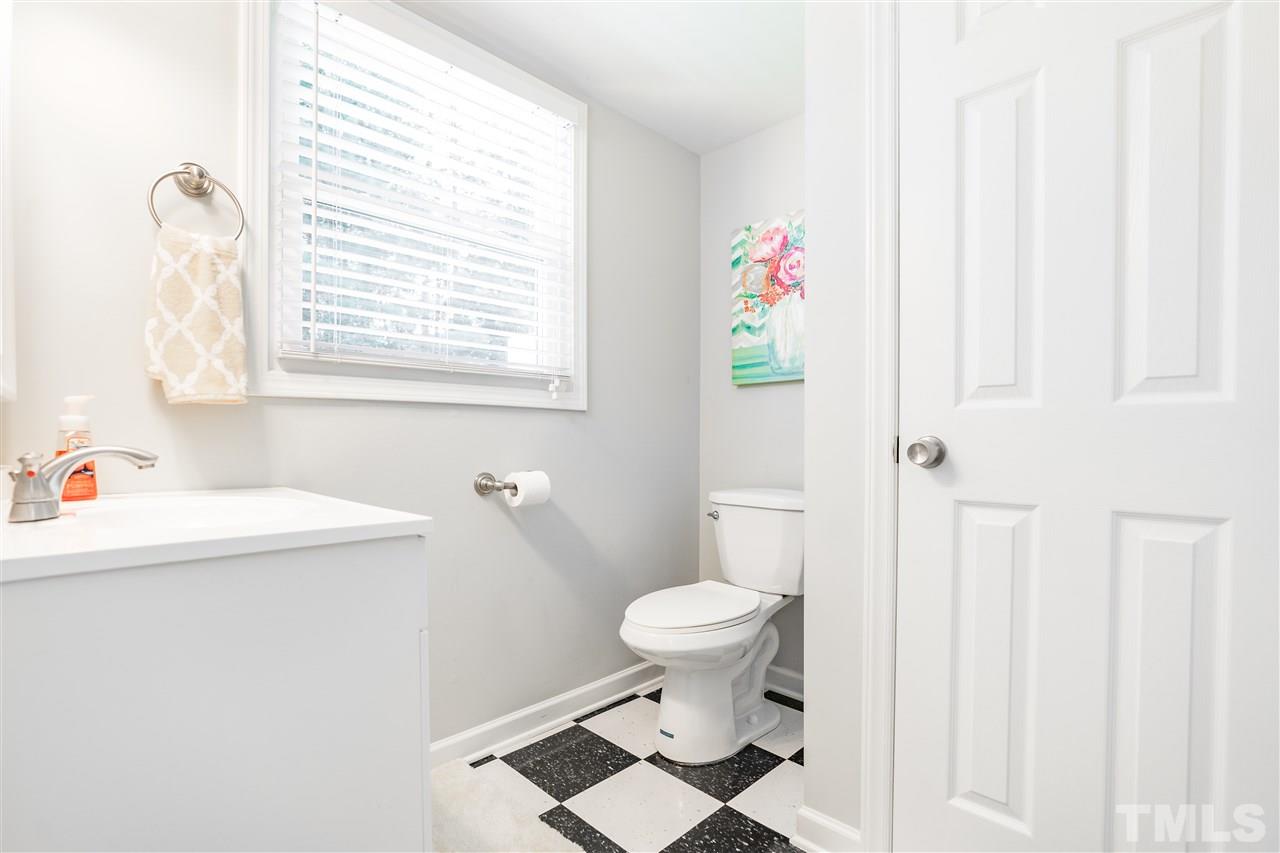 1005 Plateau Lane Raleigh, NC 27615 - Photo 24 of 29 a bathroom with a sink toilet and window