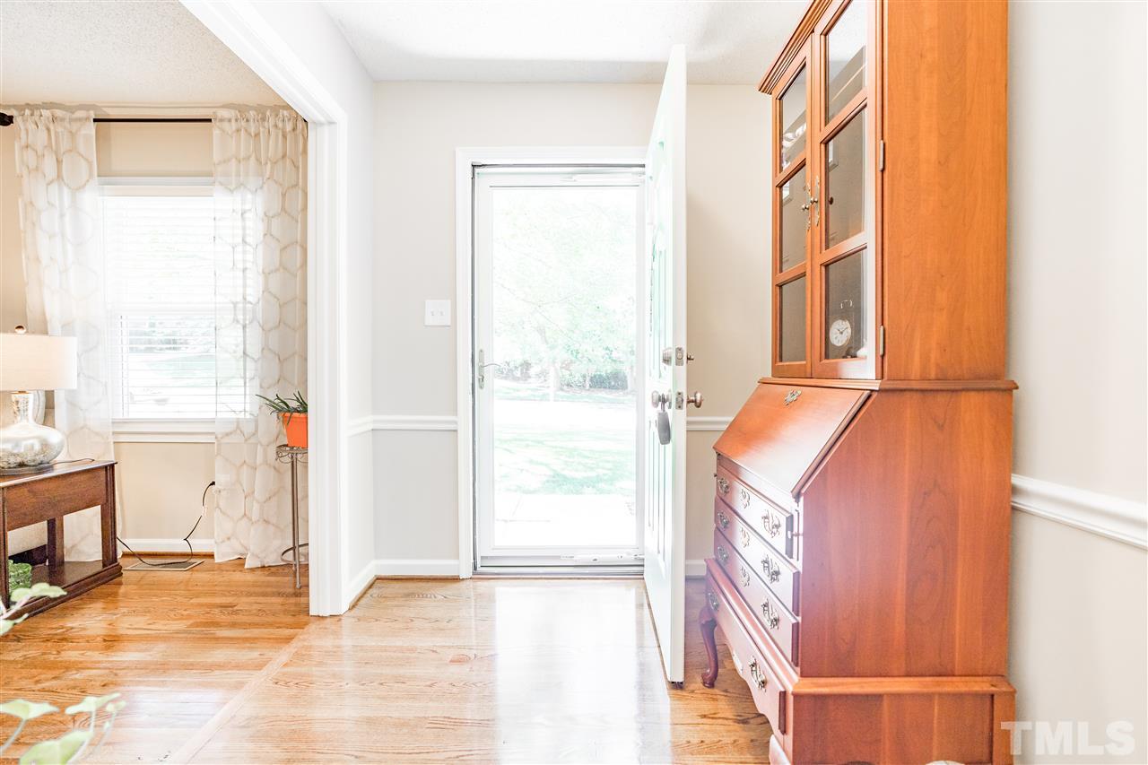 1005 Plateau Lane Raleigh, NC 27615 - Photo 5 of 29 a view of an empty room with wooden floor and a window