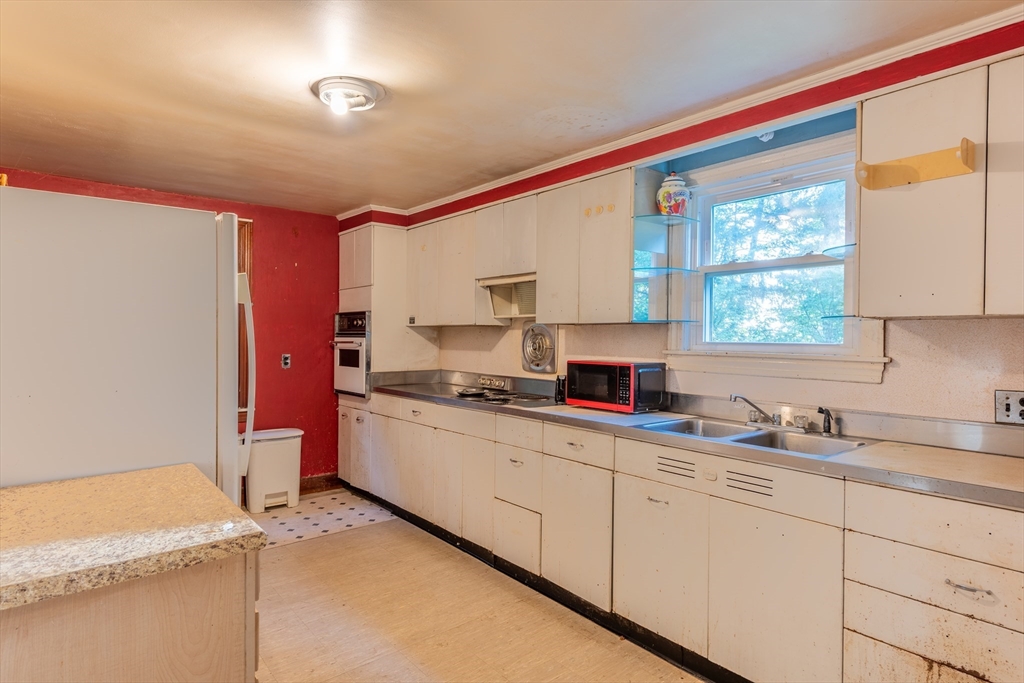 12 Moorland Street Amherst, MA 01002 - Photo 12 of 25 a kitchen with sink cabinets and window