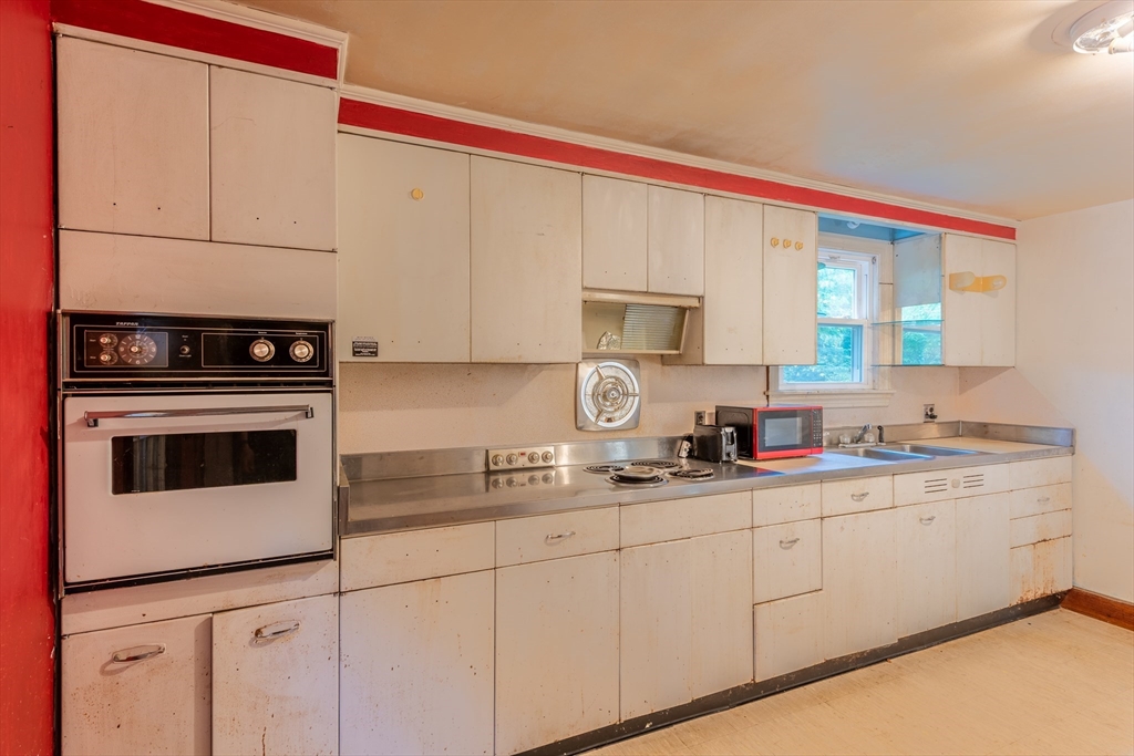 12 Moorland Street Amherst, MA 01002 - Photo 13 of 25 a kitchen with stainless steel appliances granite countertop a sink stove and cabinets