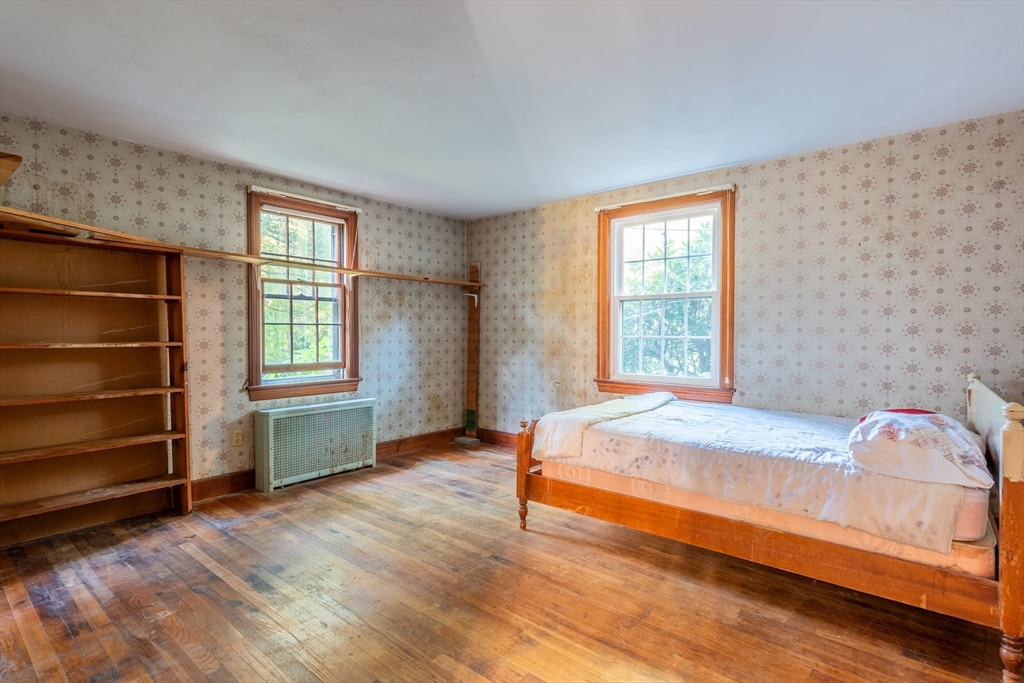 12 Moorland Street Amherst, MA 01002 - Photo 17 of 25 a bed sitting in a bedroom next to a window
