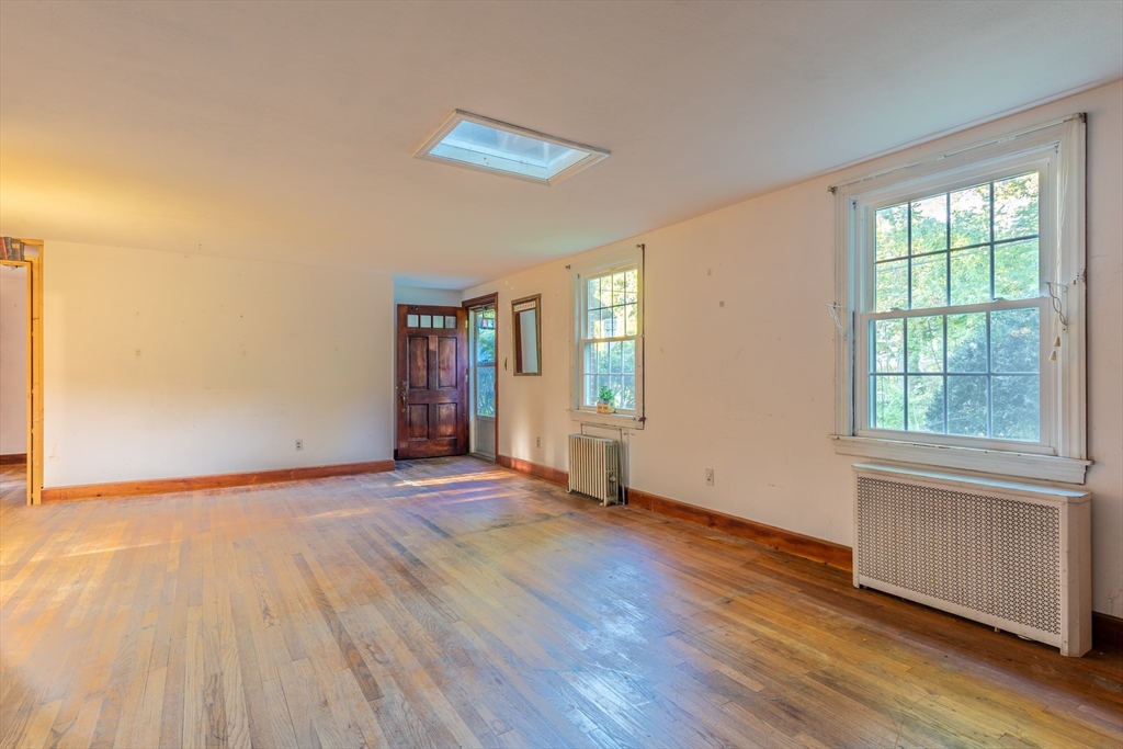 12 Moorland Street Amherst, MA 01002 - Photo 9 of 25 a view of an empty room with wooden floor and a window