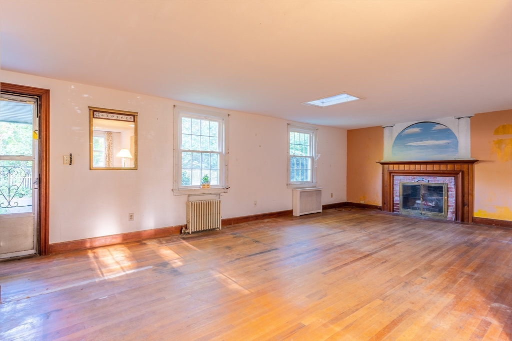 12 Moorland Street Amherst, MA 01002 - Photo 10 of 25 an empty room with windows and fireplace