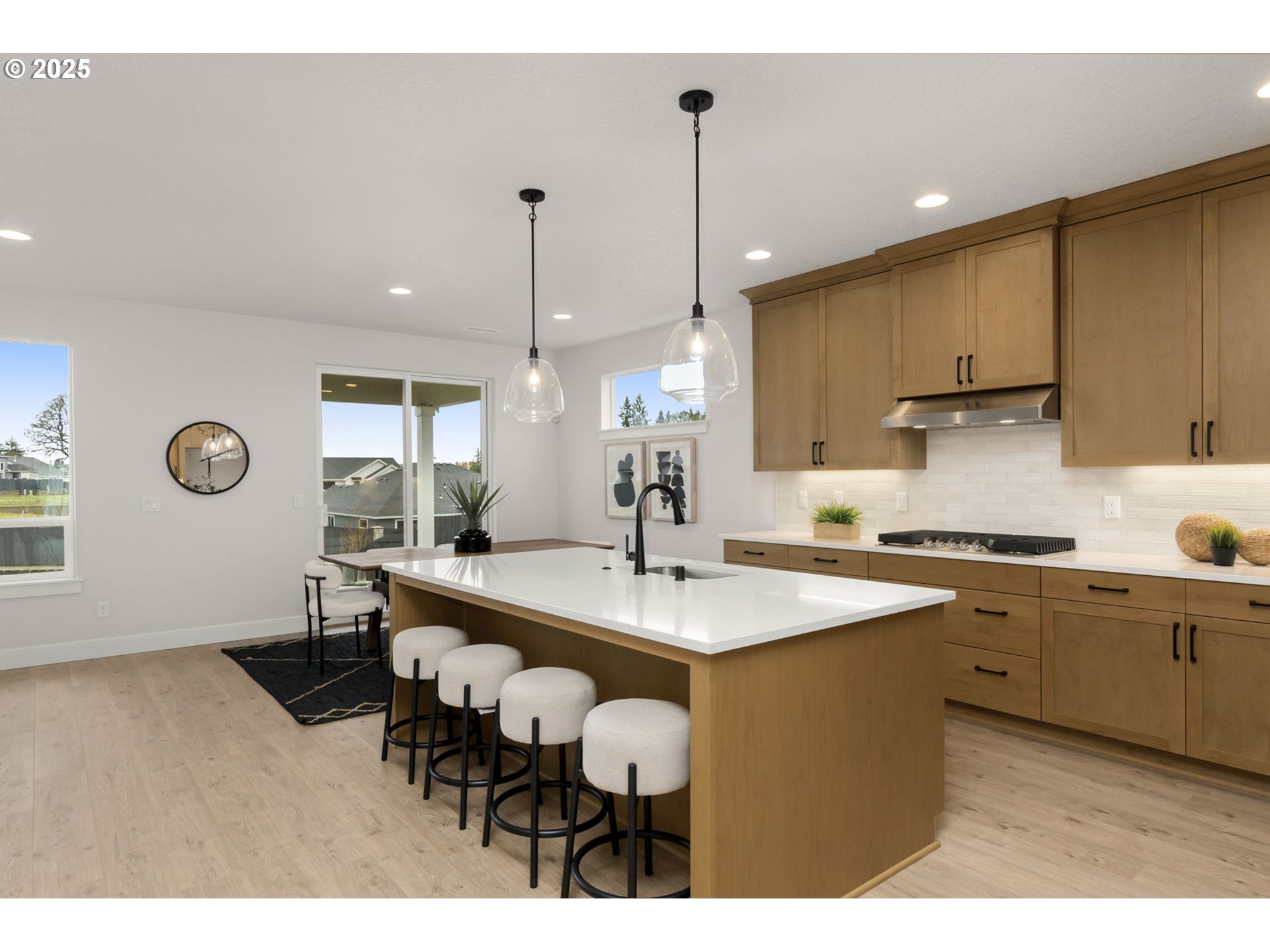 4117 South 14th Way Ridgefield, WA 98642 - Photo 7 of 20 a kitchen with stainless steel appliances granite countertop a sink a stove and a wooden floors